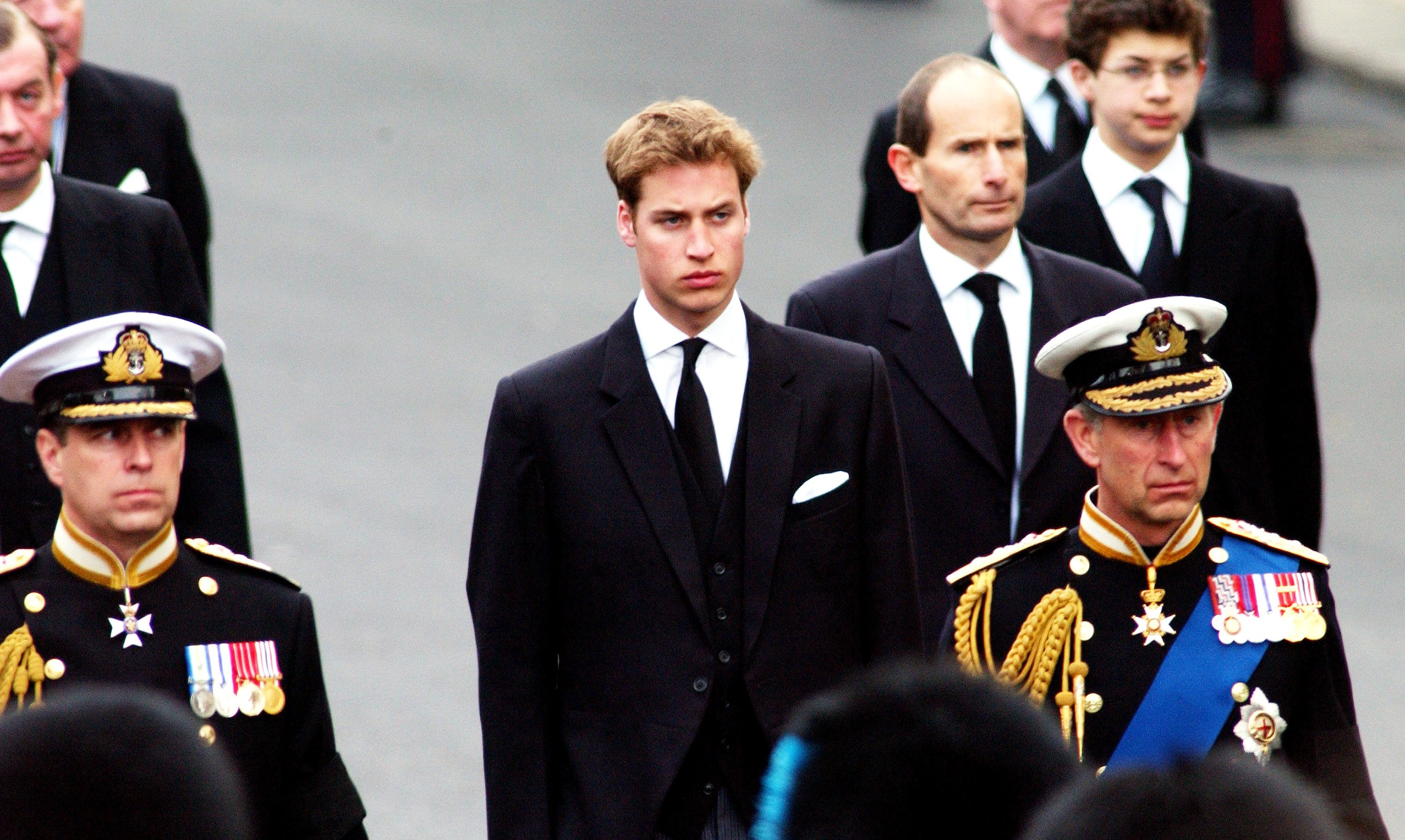 Britain's Prince Charles (R) Prince Andrew (L) and Prince William (C) walk behind the Gun Carriage bearing the coffin of the Queen Mother April 9, 2002 as it makes its way to Westminster Abbey during her state funeral April 9, 2002 in London.