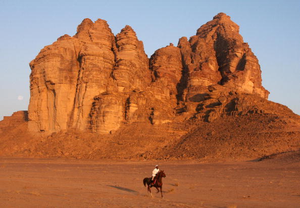a jockey and his horse in wadi rum a jockey and his horse in wadi rum