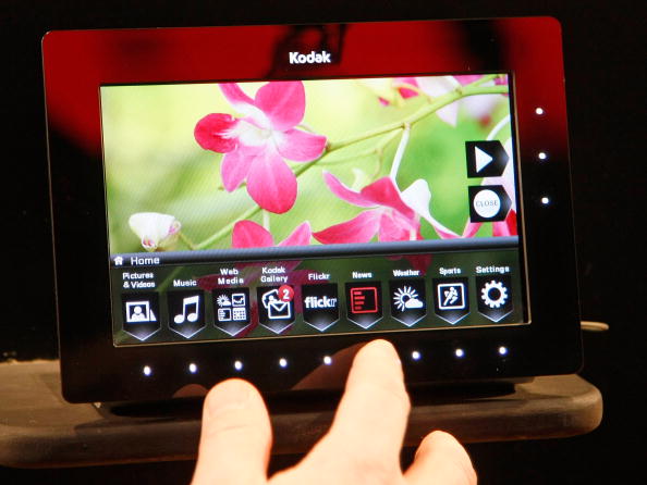a hand demonstrates a digital photo frame a hand demonstrates a digital photo frame