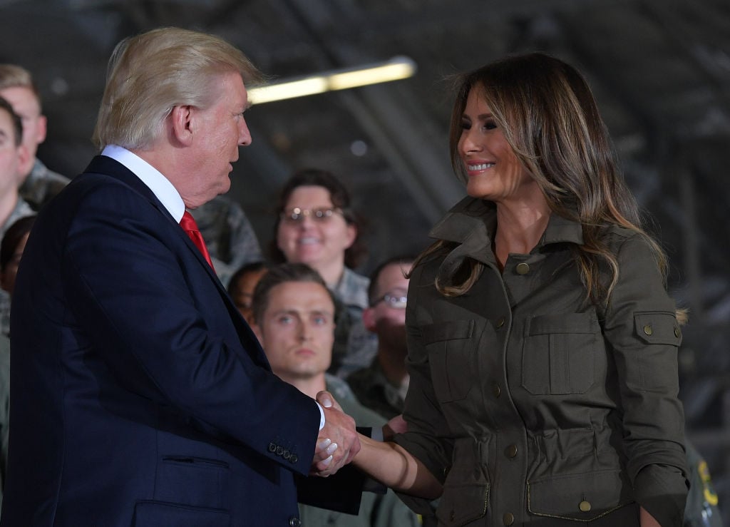 Donald Trump and Melania Trump shake hands.