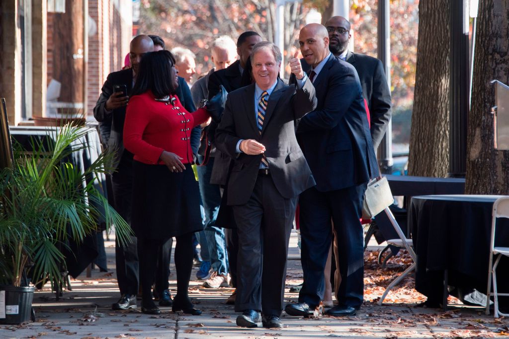 doug jones walks with other canvassers before the election doug jones walks with other canvassers before the election