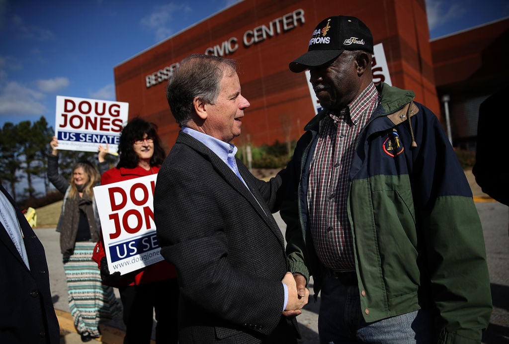 doug jones shakes hands with a voter outside a polling center doug jones shakes hands with a voter outside a polling center