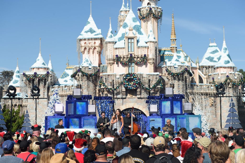 Lea Michele performs the holiday favorite "Let It Snow" from Sleeping Beauty Castle at Disneyland.