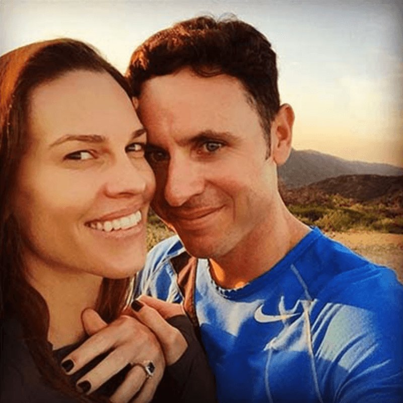 Hilary Swank and her fiancé posing with her engagement ring. Hilary Swank and her fiancé posing with her engagement ring.