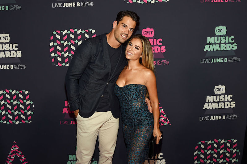 Eric Decker and Jessie James Decker smiling and hugging on a red carpet. Eric Decker and Jessie James Decker smiling and hugging on a red carpet.