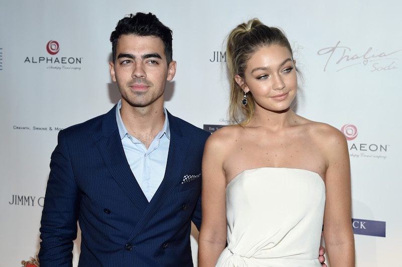 Joe Jonas and Gigi Hadid pose together on a red carpet. Joe Jonas and Gigi Hadid pose together on a red carpet.