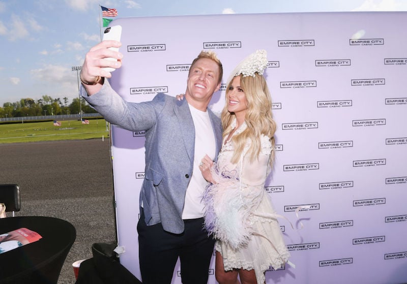 Kroy Biermann and Kim Zolciak taking a selfie together and smiling. 