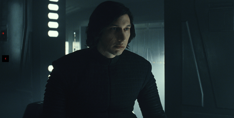 Kylo Ren sits inside a room while wearing black clothes.