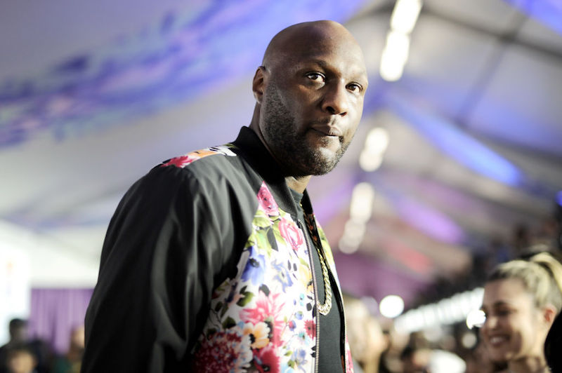 Lamar Odom in a black and floral jacket. 