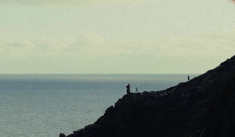 Rey seen holding a lightsaber from a distance. Rey seen holding a lightsaber from a distance.