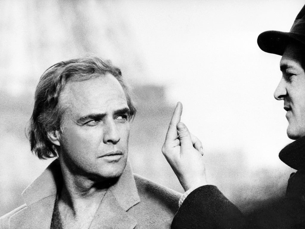 Marlon Brando receives direction during filming.