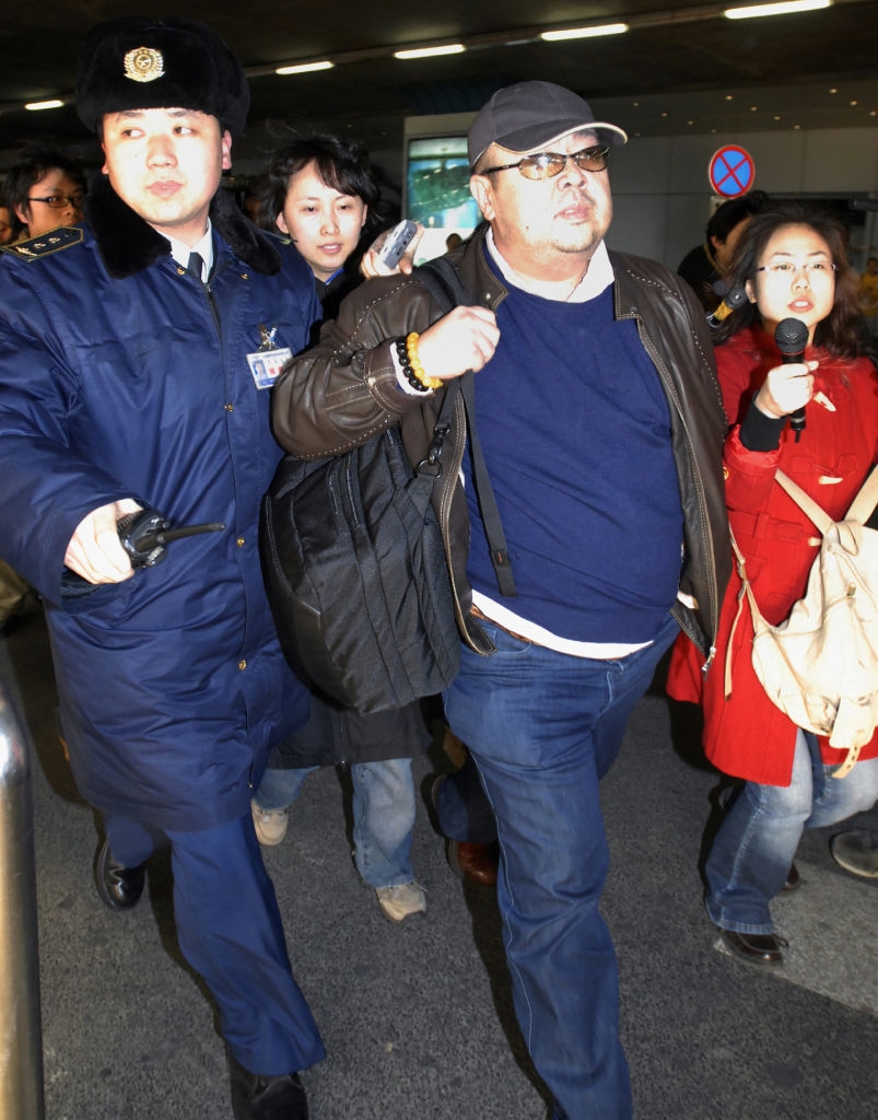 This photo taken on February 11, 2007 shows a man believed to be then-North Korean leader Kim Jong-Il's eldest son, Kim Jong-Nam (C), walking amongst journalists upon his arrival at Beijing's international airport.