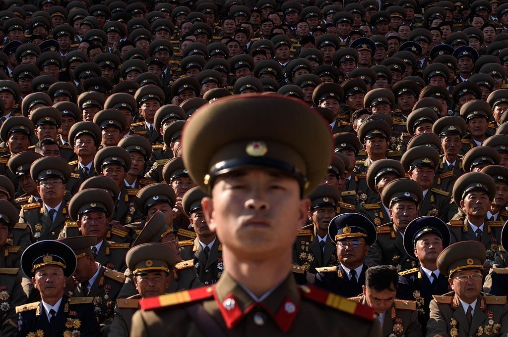 A North Korean soldiers stands before spectators during a mass military parade.