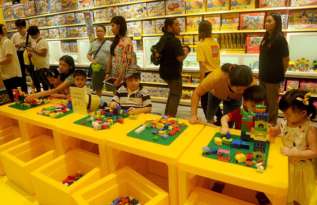 Children play with Lego blocks during the opening of the brand's first certified store