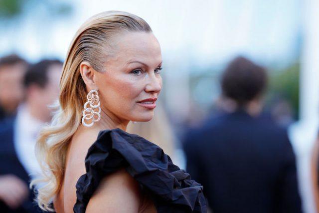 Pamela Anderson poses in a ruffled gown and silver earrings. Pamela Anderson poses in a ruffled gown and silver earrings.