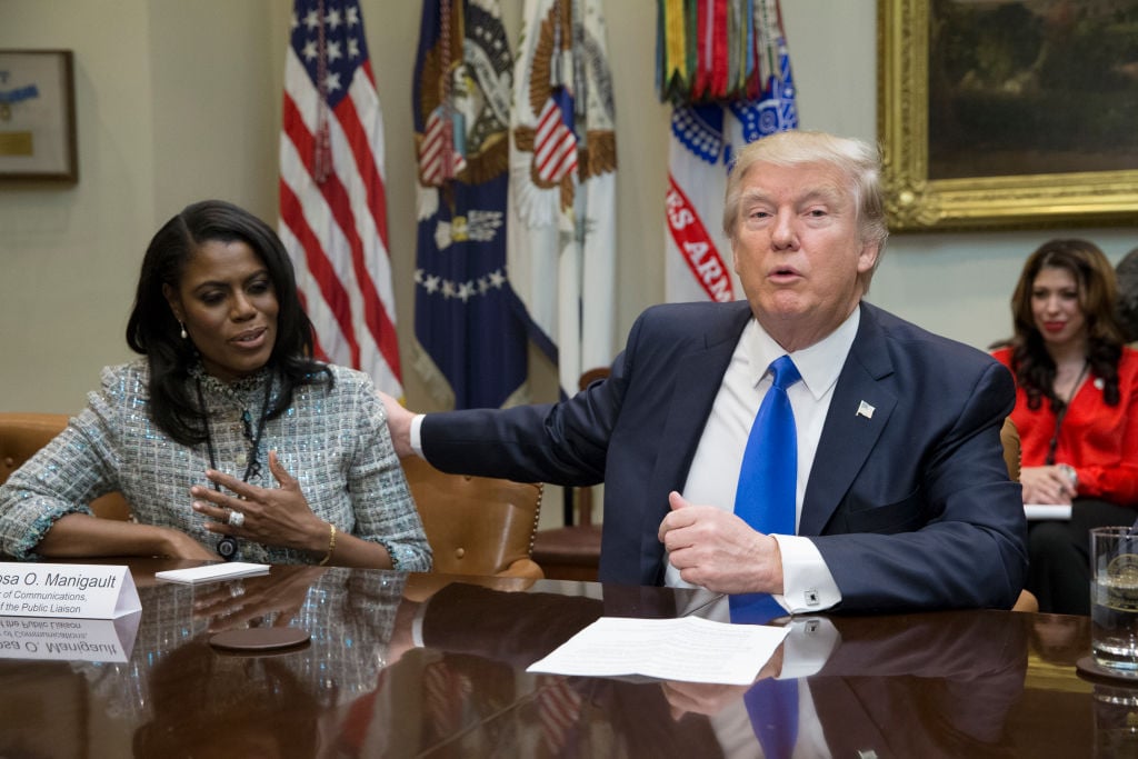 Omarosa Manigault Newman and Donald Trump at the desk