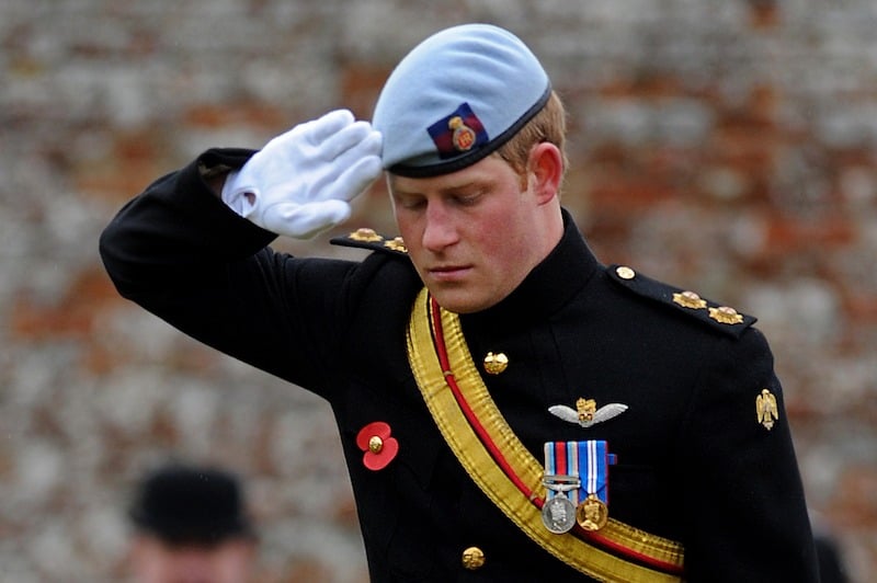 Britain's Prince Harry, salutes after laying a cross of remembrance in memory of his friend Lance Corporal