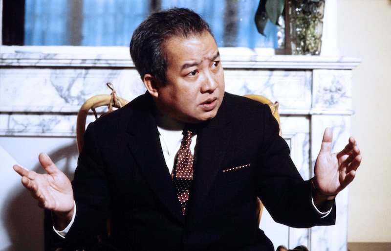 Prince Norodom sits while raising his hands. Prince Norodom sits while raising his hands.