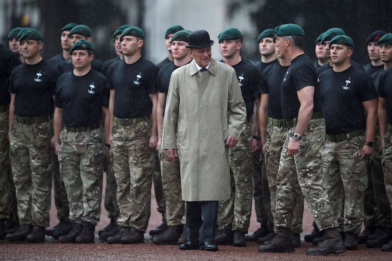 Prince Phillip stands in front of a group of young soldiers. Prince Phillip stands in front of a group of young soldiers.