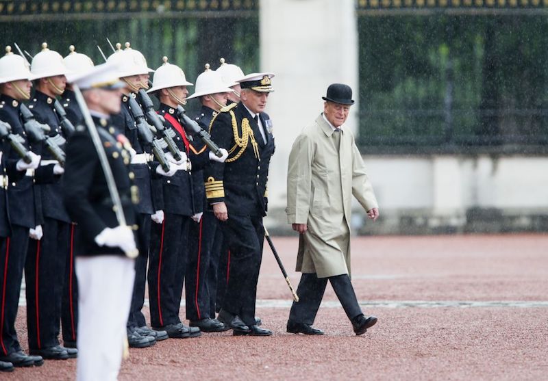 Prince Charles leading a march in front of soldiers. 