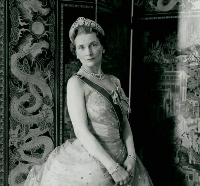 Princess Alice poses in a sash and tiara. 