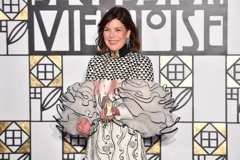 Princess Caroline of Hanover stands in a gown in front of a patterned wall. Princess Caroline of Hanover stands in a gown in front of a patterned wall.