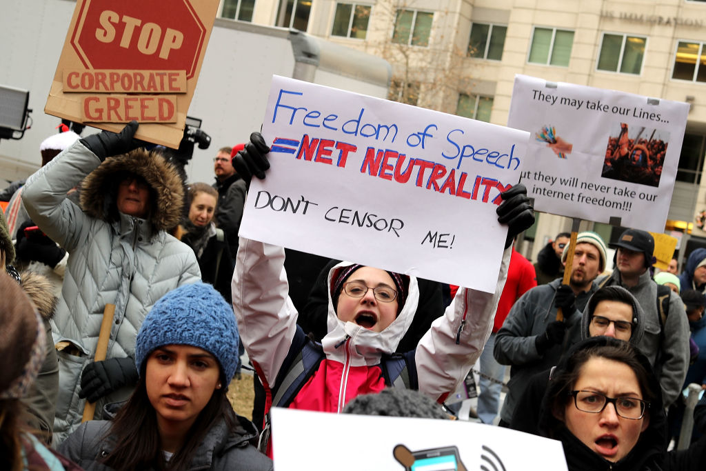 WASHINGTON, DC - DECEMBER 14: Demonstrators rally outside the Federal Communication Commission building to protest against the end of net neutralityrules December 14, 2017 in Washington, DC. Lead by FCC Chairman Ajit Pai, the commission is expected to do away with Obama Administration rules that prevented internet service providers from creating different levels of service and blocking or promoting individual companies and organizations on their systems. (Photo by Chip Somodevilla/Getty Images) Demonstrators rally outside the Federal Communication Commission building to protest against the end of net neutralityrules
