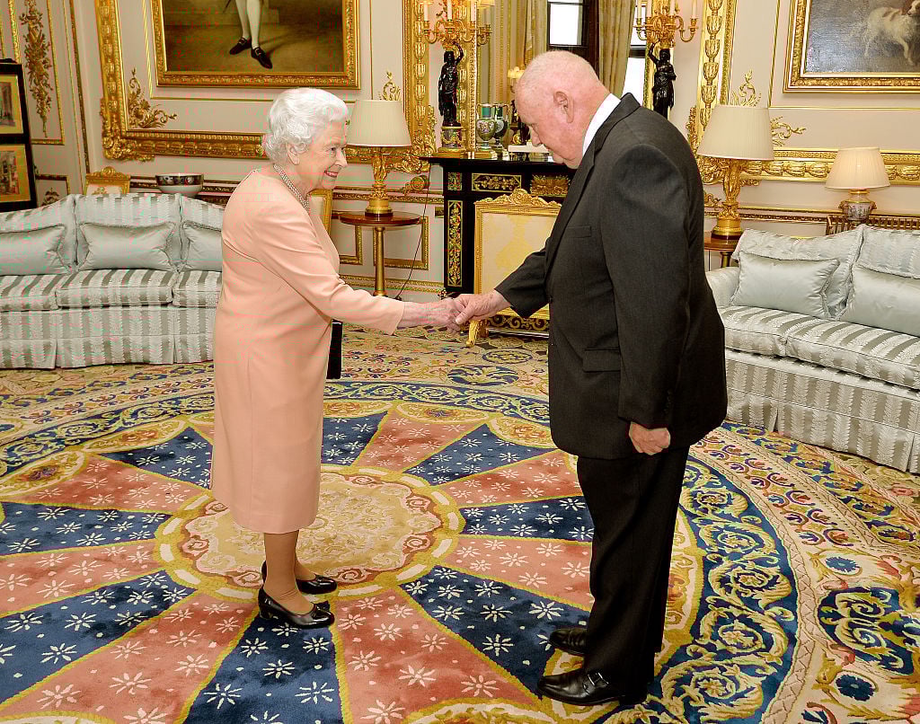 American businessman John Mars Queen Elizabeth II shakes hands with American businessman John Mars