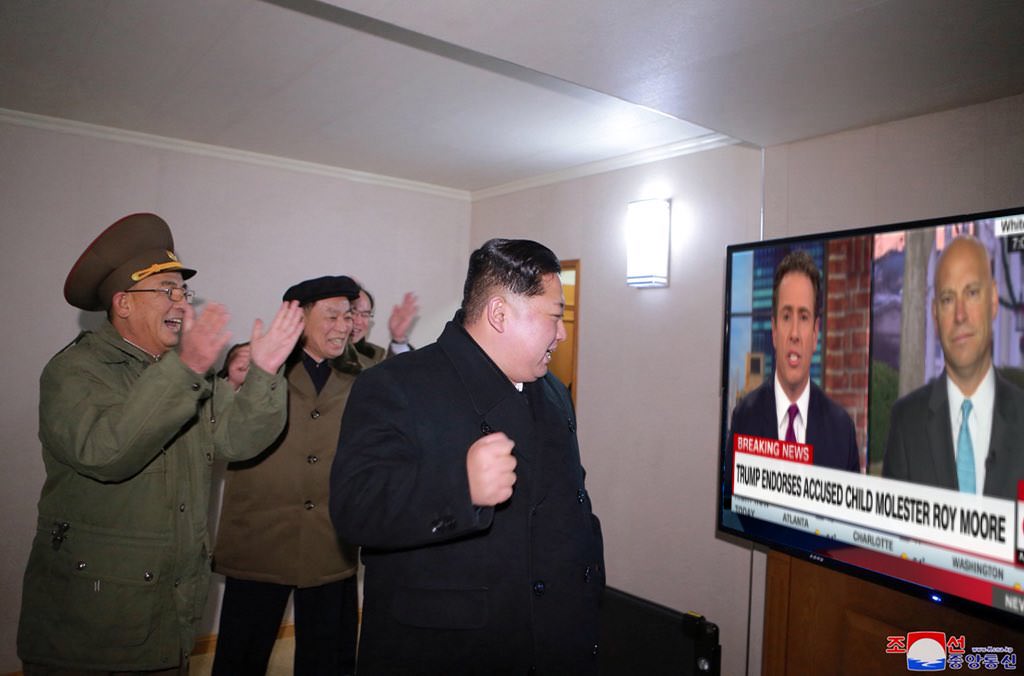 Kim Jong Un in front of a tv