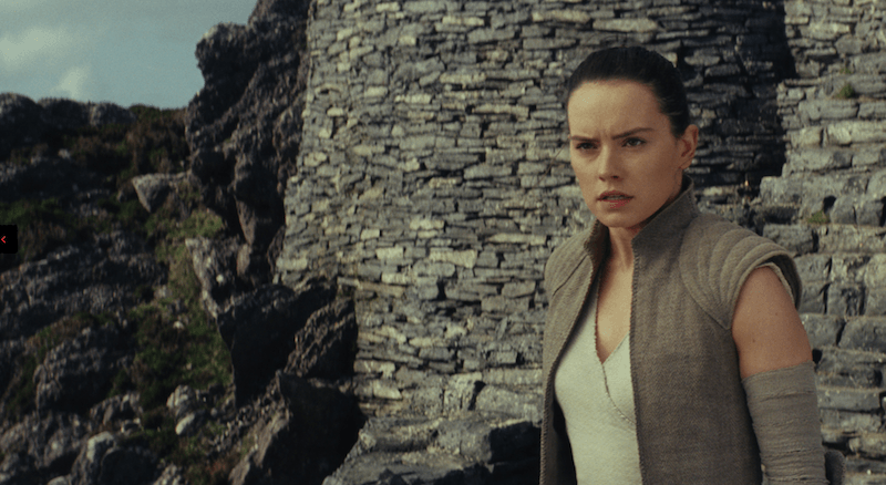 Rey stands in front of a brick wall Rey stands in front of a brick wall