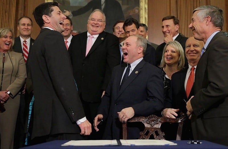 Shot of Speaker Paul Ryan laughing hysterically with members of the Republican House caucus following a ceremony aimed at repealing the Affordable Care Act