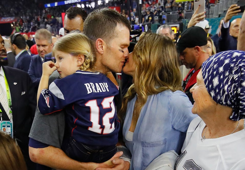 Tom Brady #12 of the New England Patriots celebrates with wife Gisele Bundchen and daughter Vivian Brady