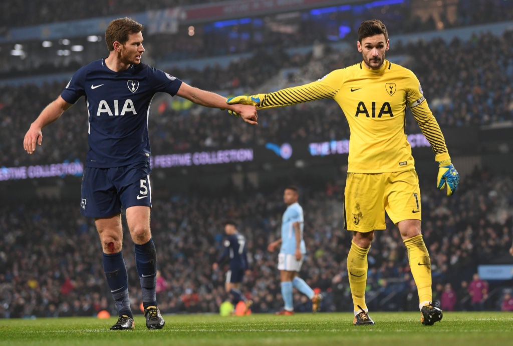 Tottenham Hotspur players touching hands