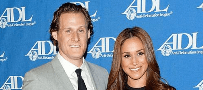 Trevor Engelson and Meghan Markle on a red carpet.