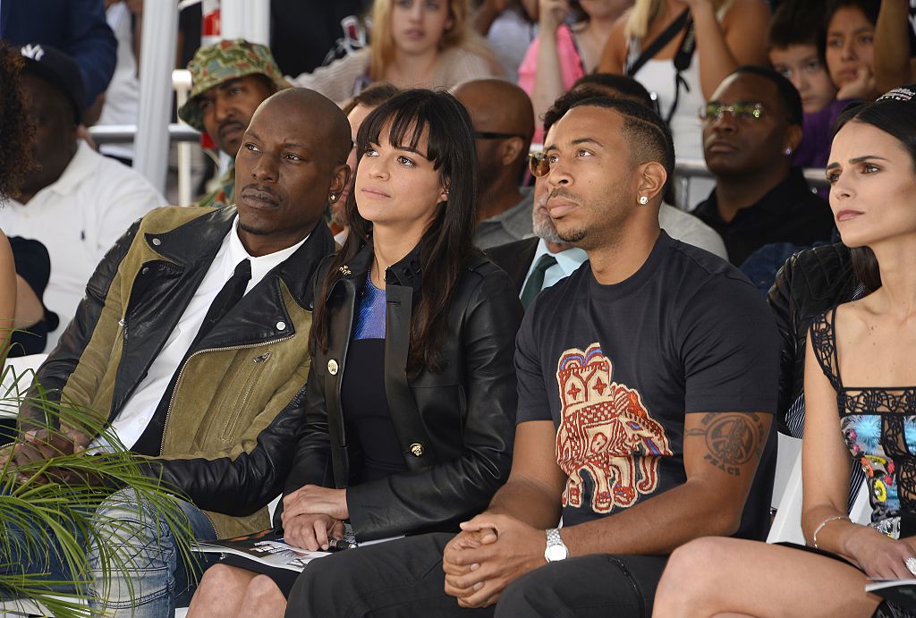 Co-stars Tyrese Gibson, Michelle Rodriguez, and Ludacris listen as actor Vin Diesel (not in photo) speaks about his friend Paul Walker. 