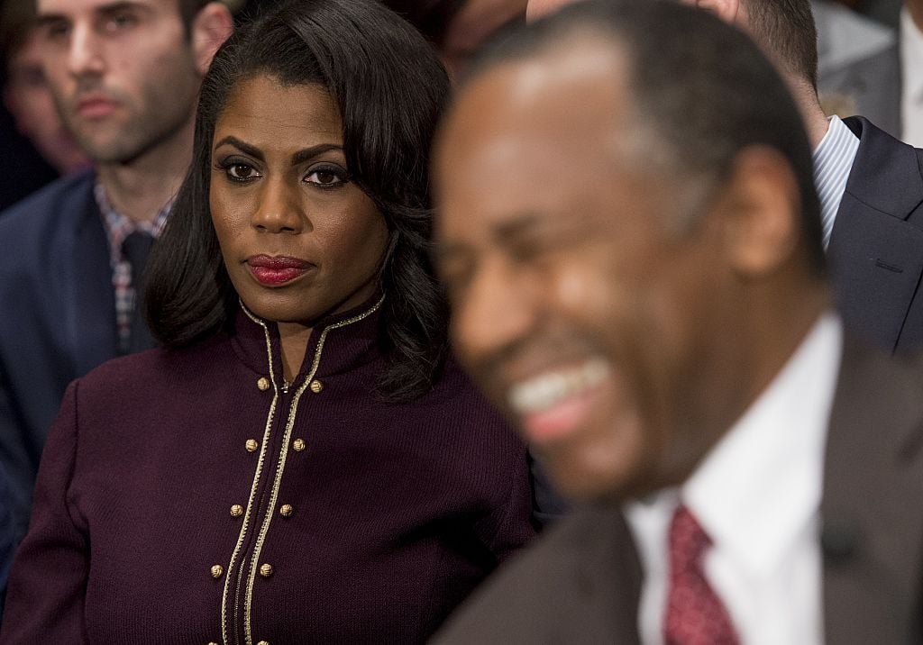 Omarosa Manigault sits near Ben Carson as he arrives to testify during his confirmation hearing
