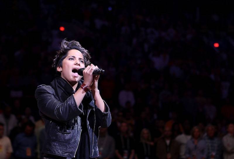 Vicci Martinez performing behind a microphone.