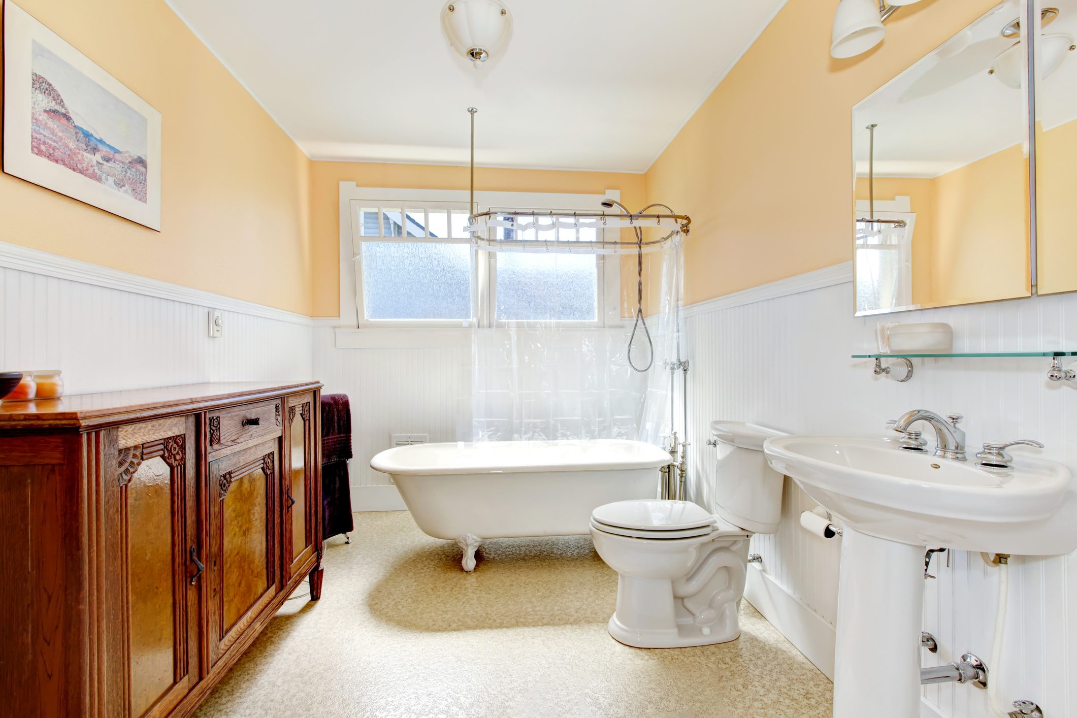 Yellow bathroom with claw foot tub