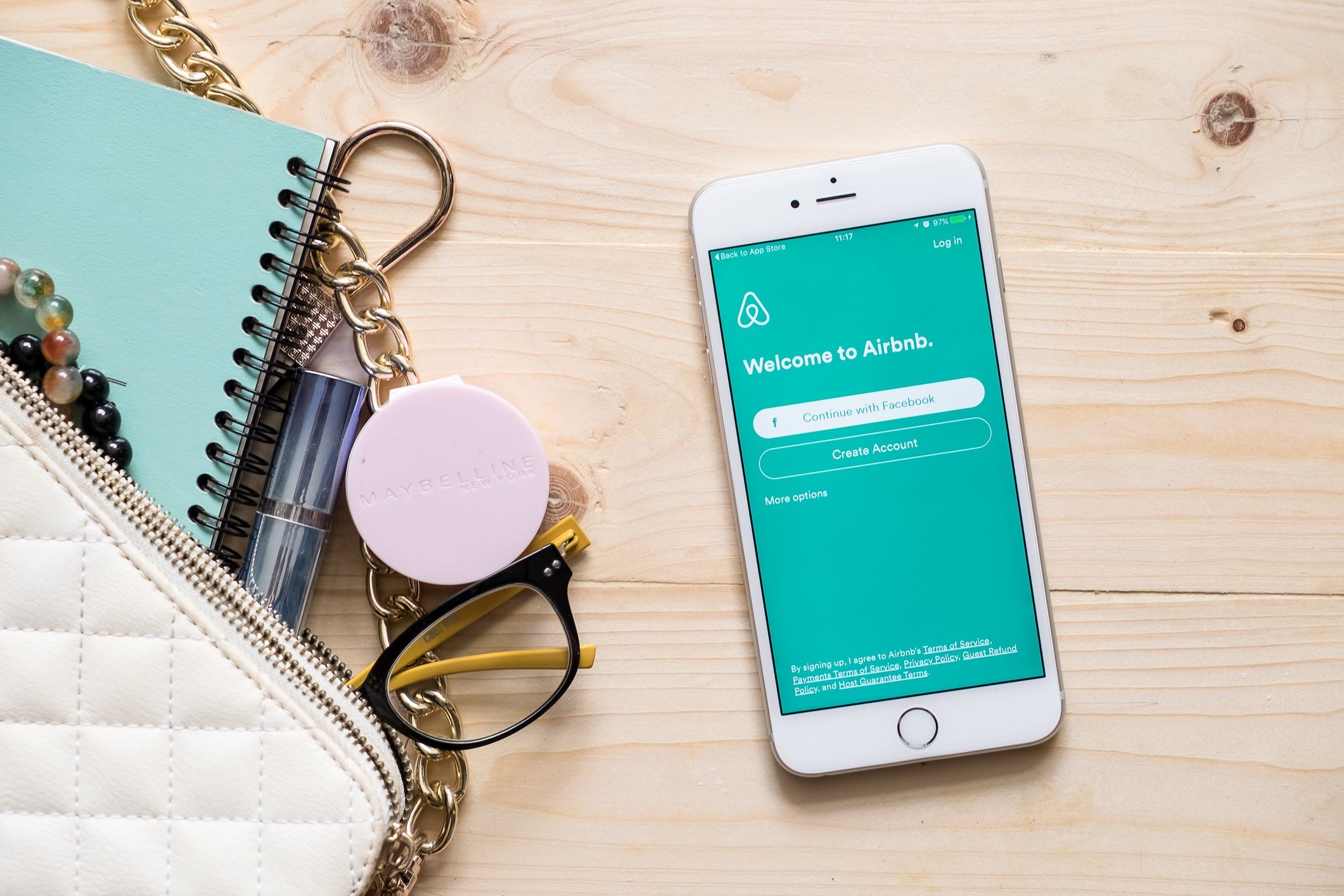 Apple iPhone 6s plus with Airbnb application on the screen.