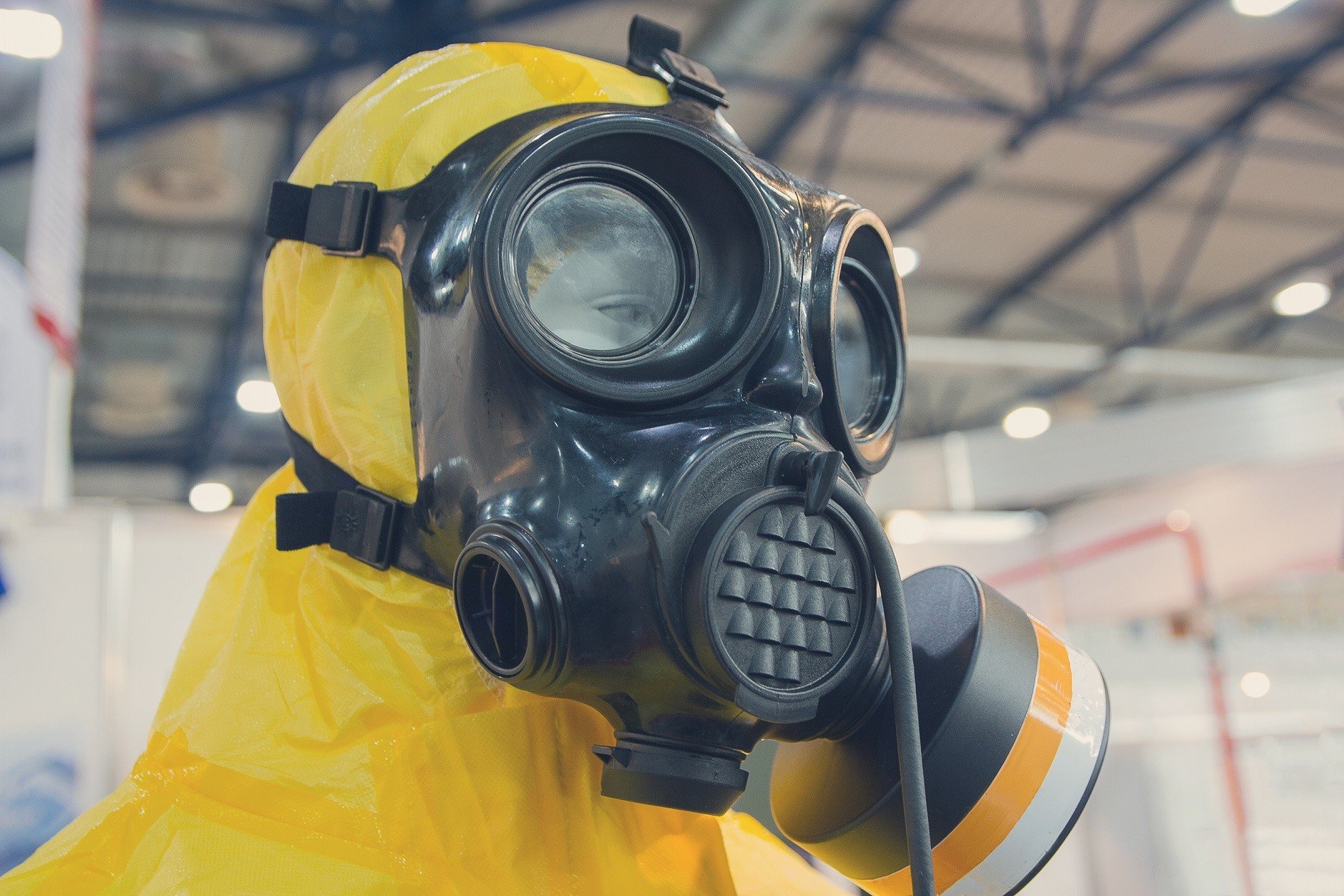 Gas mask with yellow chemical protection suit