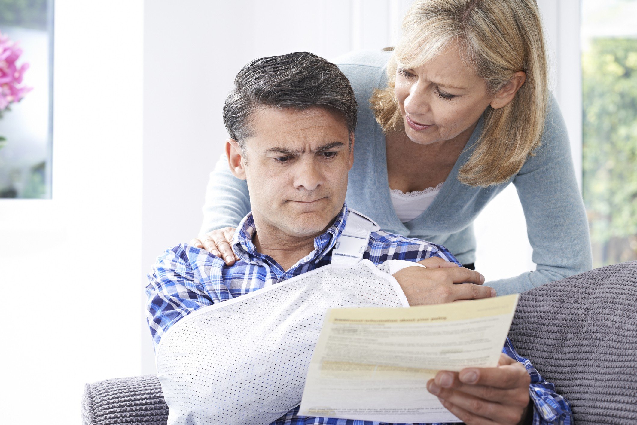 Couple Reading Letter About Husband's Injury Health care bill