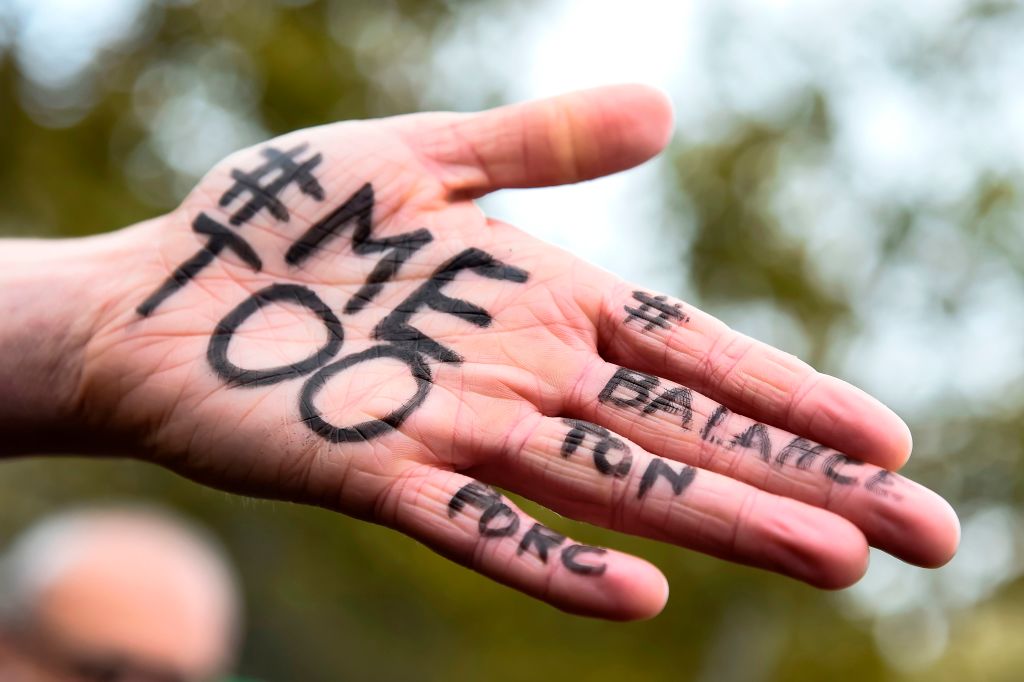 A picture shows the messages "#Me too" and #Balancetonporc ("expose your pig") on the hand of a protester during a gathering against gender-based and sexual violence called by the Effronte-e-s Collective, on the Place de la Republique square in Paris on October 29, 2017. Me too sexual harassment