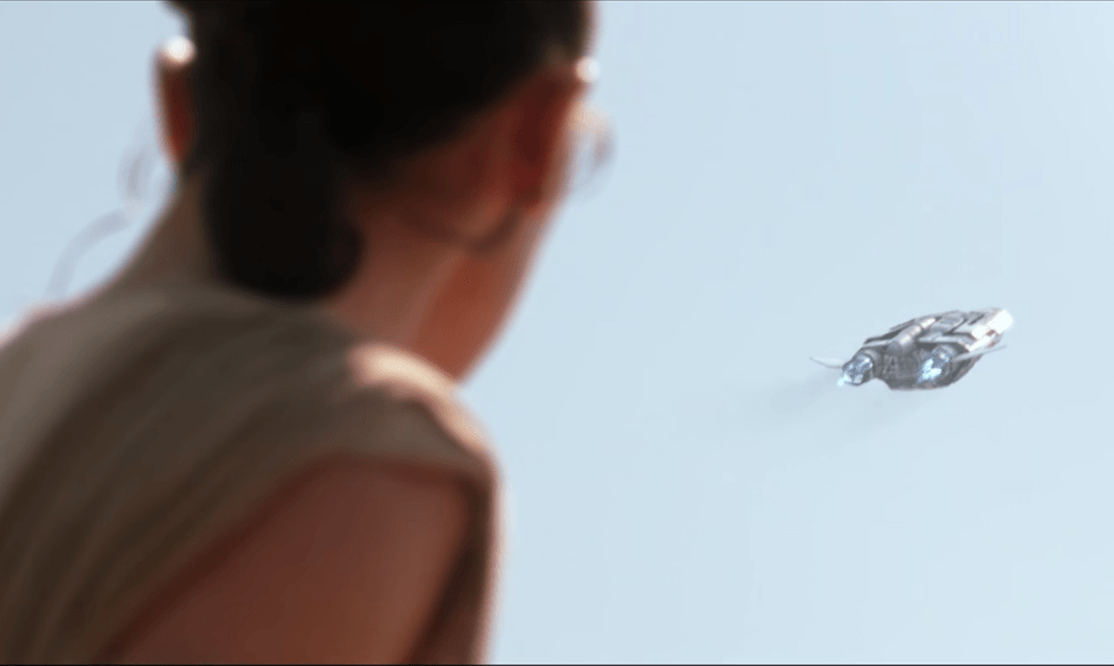 Rey watches a ship in Star Wars: The Force Awakens