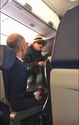 The woman began yelling as flight attendants tried to calm her The woman began yelling as flight attendants tried to calm her