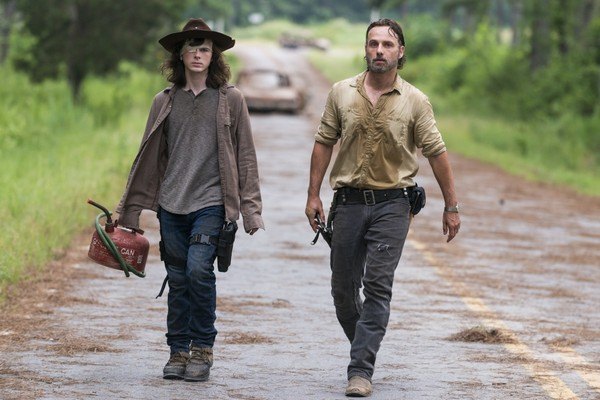 Rick and Carl walk next to each other down a road on The Walking Dead Rick and Carl walk next to each other down a road on The Walking Dead