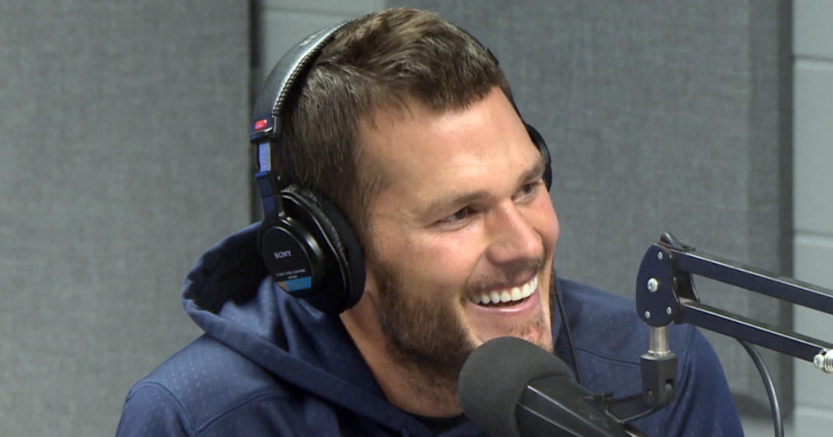 Tom Brady wears headphones and talks into a radio mic Tom Brady wears headphones and talks into a radio mic