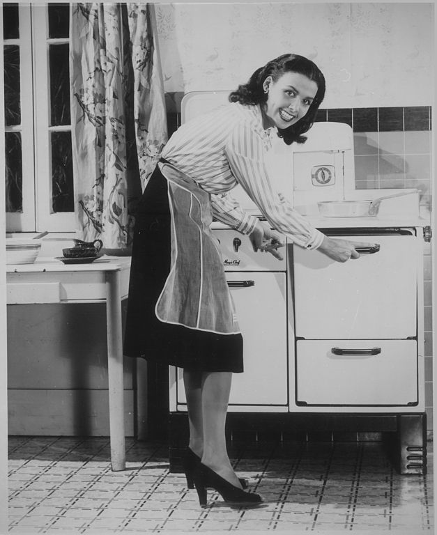 woman using a 1940s stove