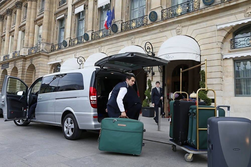 An employee from the Ritz luxury hotel loads luggage in a van in Paris