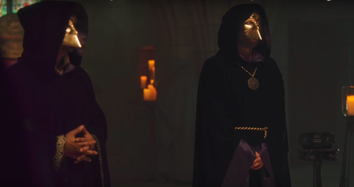 Two men dressed in cloaks and face masks. Two men dressed in cloaks and face masks.