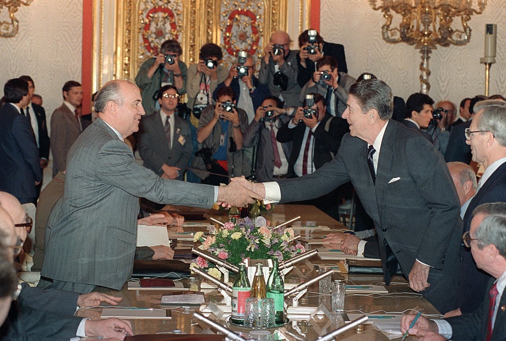 US President Ronald Reagan shown in a photo shaking hands with Soviet leader Mikhail Gorbachev